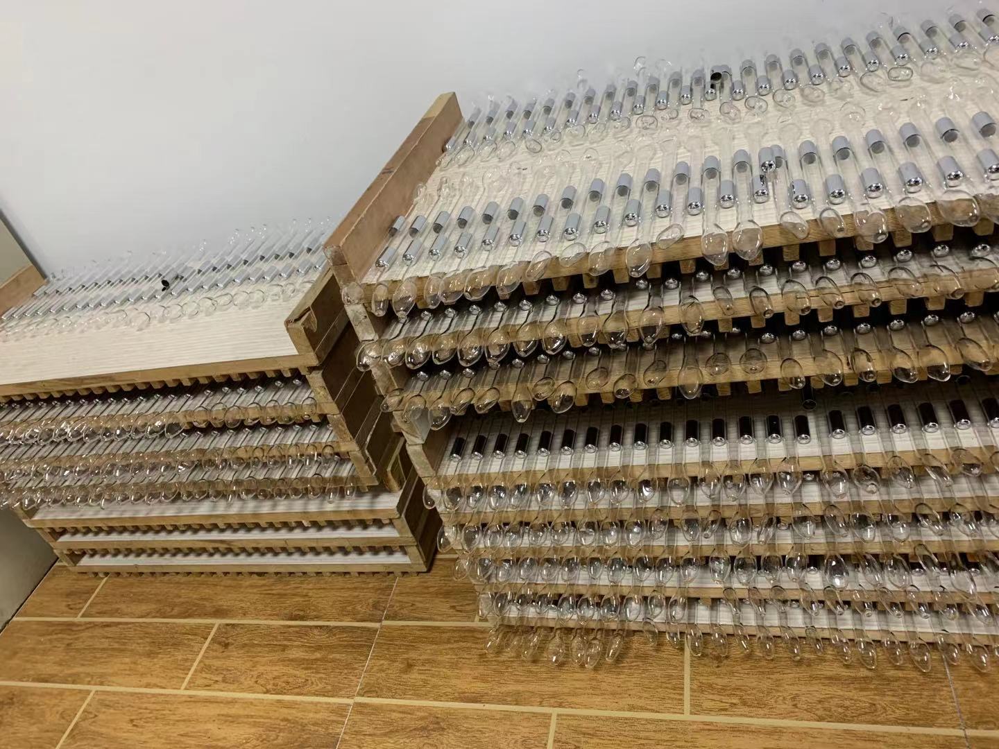 Batch of spoon-shaped glass electrodes on storage racks